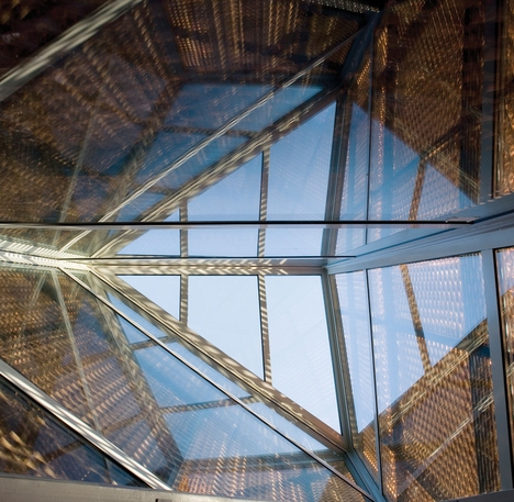 Natural light enters the building through the glass and mesh-clad “chimney”.