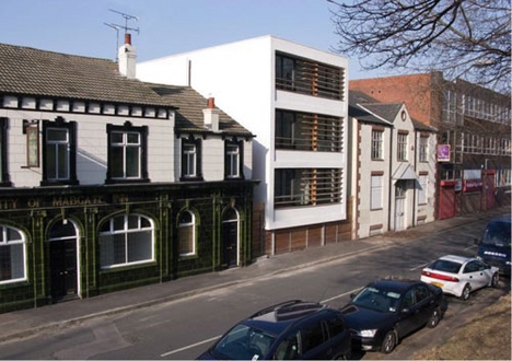 Tao eco-apartments sit between two older buildings