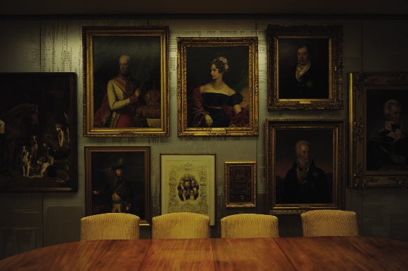 Paintings are gathered together on feature walls, hung on milled aluminium panelling.