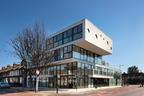 With its cantilevered white planes and continuous glazing, the building stands like a cruise liner  run aground at the end of a suburban street.