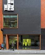 The thick timber-framed windows are slid into the facade “like the lid of a pencil box”.