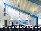Exposed steel structure inside a classroom at Penoyre & Prasad's Wren Academy.