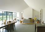 The living room looks on to the paddock through a wall of Crittall glazing.
