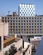 The lower brick block with the aluminium-clad tower behind in Southwark, south London.