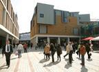 Pedestrians stroll between Panter Hudspith’s Debenhams, left, and a mixed-use pavilion.