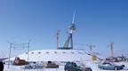 Erection of the tripod mast last December above the snow-covered 20m-high concrete base.