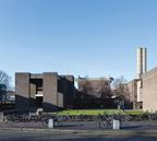 It is a short bicycle ride from Cambridge to the out-of-town college with its temple-like main entrance in purplish-buff brickwork.