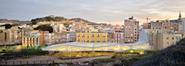 The faceted roof canopy is designed to mediate between the town and the sloping park beyond.
