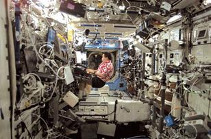 NASA astronaut Edward Lu plays a musical keyboard inside the US laboratory module Destiny in October 2003.