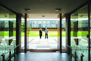 Denise and Rab Bennetts in front of the lawn at St Catherine’s College. Behind is one of the two original study-bedroom blocks.