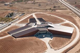 The winery's trefoil form nestles in the vineyards of the Ribera del Duero.