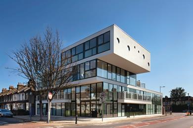 With its cantilevered white planes and continuous glazing, the building stands like a cruise liner  run aground at the end of a suburban street.