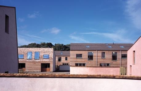 The houses are configured in terraces of three.