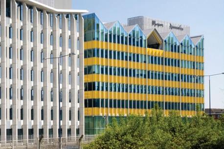 The west facade seen from the West Cross Route. The second phase of AHMM’s Notting Hill Village project is to the left.