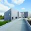 The gallery’s cluster of concrete containers are huddled at the end of a new footbridge to the town centre.