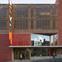 The facade is slightly cranked inwards, providing shelter under a projecting canopy