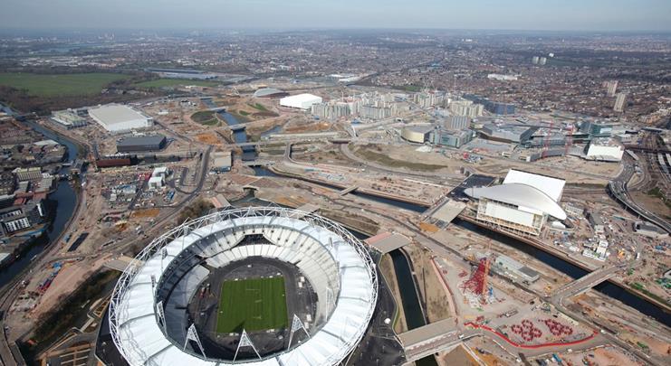 The stadium sits on its own island at the southern end of the Olympic Park. The Aquatics Centre and Orbit sculpture are to its right.