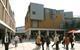 Pedestrians stroll between Panter Hudspith’s Debenhams, left, and a mixed-use pavilion.